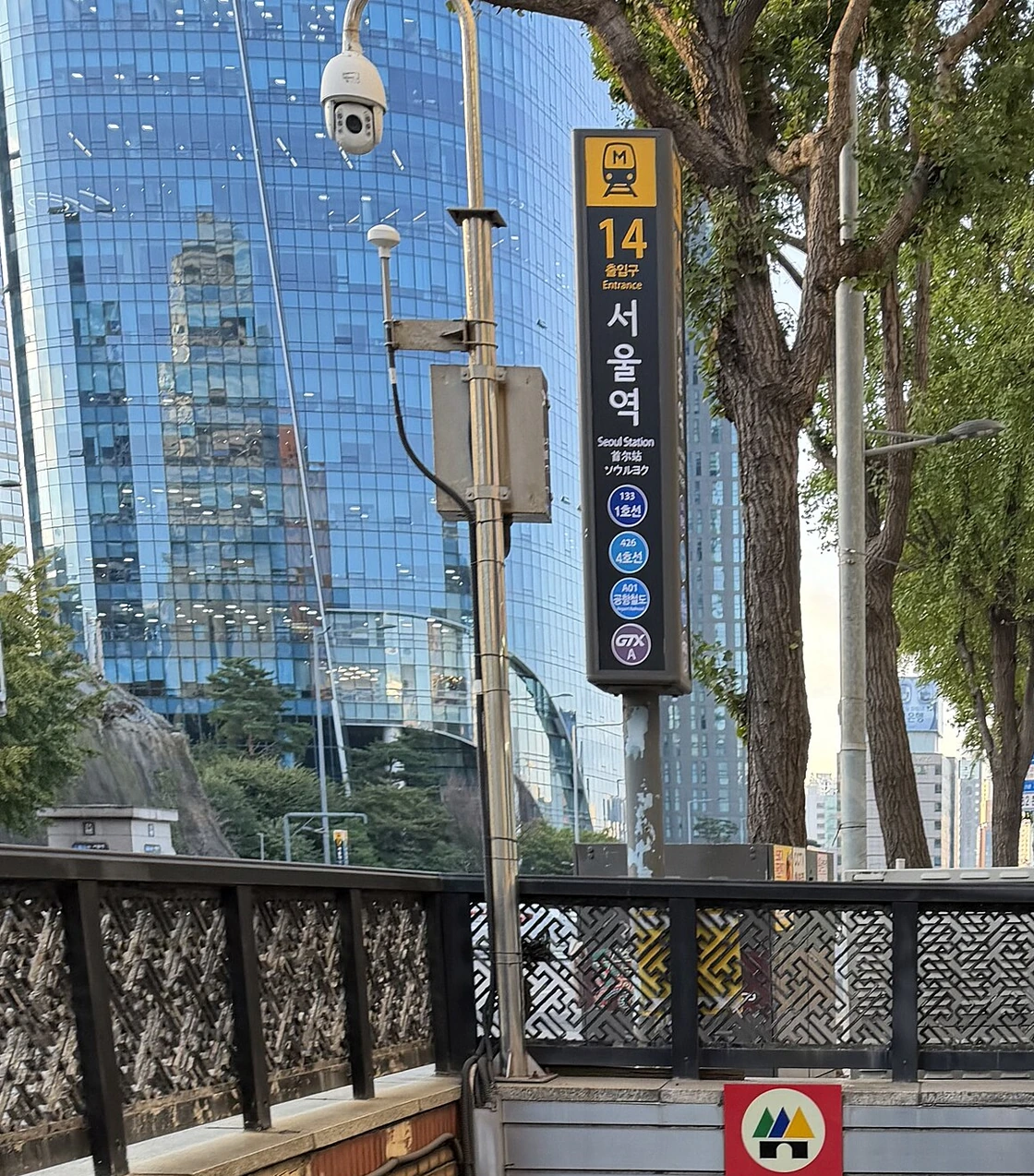 Seoul Station Exit 14 entrance with numbered multilingual subway signs on a city street